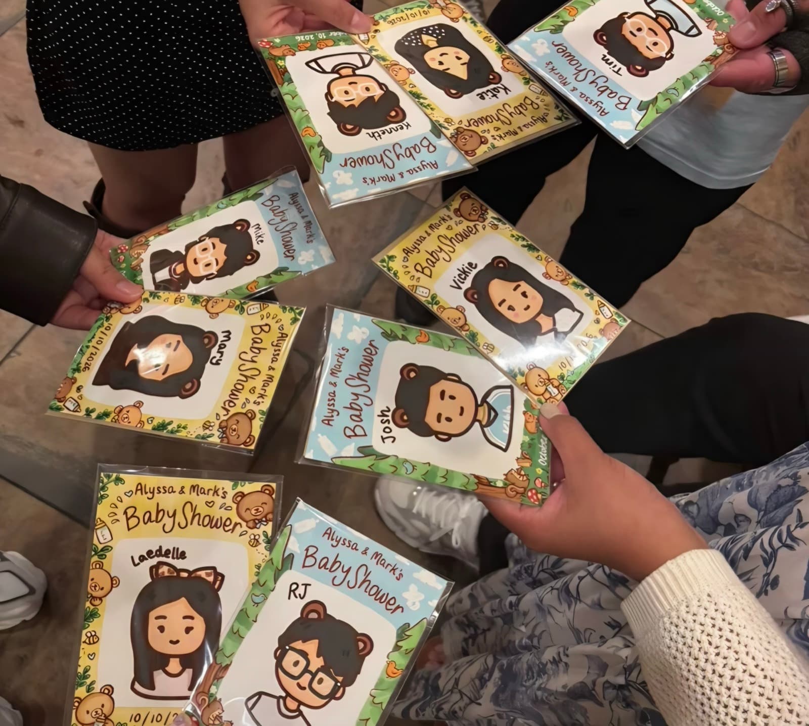 Guests holding framed doodle portraits from Alyssa and Mark's baby shower.